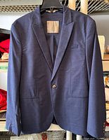 Full front view of navy Zara Man blazer on hanger