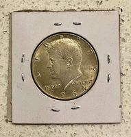 Obverse view of 1964 Kennedy half-dollar in flip