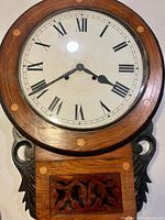 Front view of drop dial wall clock showing dial and case