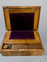 Open writing slope showing purple velvet panel, storage compartment, and inkwell