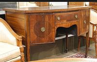 Front view showing entire sideboard, drawers, cupboard doors, brass pulls, inlay and legs