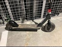 Left side view of full scooter showing deck, rear wheel and frame