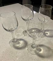 All four Rosenthal crystal wine glasses grouped on countertop