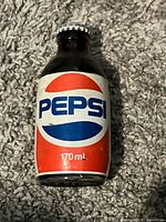Front view of sealed 170 mL Pepsi bottle showing logo and capacity