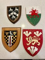 All four wooden heraldic plaques