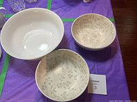 Large plain white bowl alongside two patterned bowls