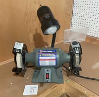 Front view of King Canada 6-inch bench grinder showing both wheels, base switch, and work light