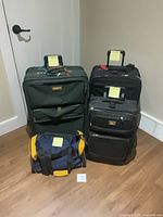 Front view of all four luggage pieces displaying sizes and styles
