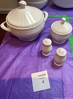 Angled view of tureen, covered bowl, salt & pepper shakers