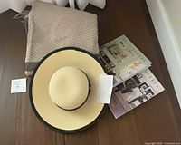 Throw blanket, sun hat, hardcover books together
