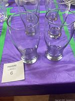 Six clear glass tumblers on table, showing overall appearance