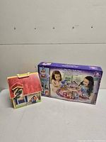 Both items side by side: boxed Disney Princess Glitter Glider Castle and Pet Clinic carry-case front view