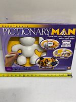 Front of boxed Electronic Pictionary Man showing contents and game details