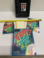 Box open showing CD sleeve, pencil slot, cards, score pad and instructions