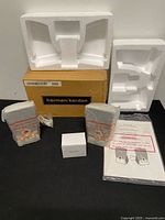 Full contents: box, styrofoam, two sealed speakers, power adapter, cables, manual