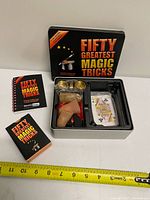 Overall view of tin, booklet, deck, internal tray with props