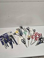 Full lot overview showing pliers set, many scissors, utility knife, sharpener