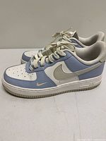 Left side view of both sneakers showing colourway and condition