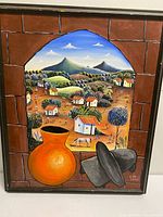 Full view of framed painting showing village scene, pottery, grinding stones