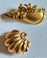 Front view of both brooches showing designs