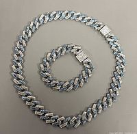 Necklace and bracelet laid flat showing full length and clasp details