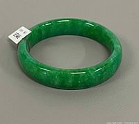 angled view of green jadeite bangle