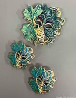 front view of brooch and earrings showing design and colours