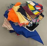 Pile of assorted scarves showing variety of colours and patterns