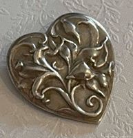 Front view showing heart shape and floral relief