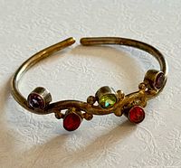 Top view of silver cuff showing multicolour gemstones