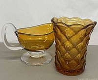 Both items side by side – gravy boat left, vase right