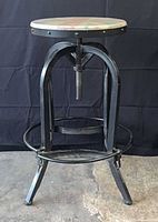 Full view of metal swivel stool showing frame and seat