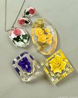 Front view of necklace pendant, earrings, three brooches