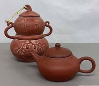 Front view showing both clay vessels and decoration