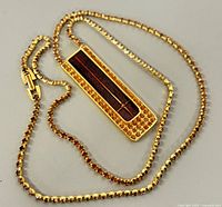 Necklace laid flat showing chain and pendant