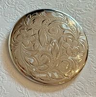 Front view of engraved sterling silver brooch