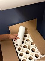Open box showing multiple white paper rolls