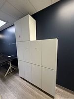 Front view showing stacked assembly of eight white Ikea SMÅSTAD cabinets