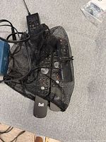 Mesh bag containing multiple remotes and power adapter