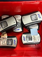 Five Purell touch-free wall dispensers in red bin