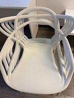 Top view of stacked white Structube dining chairs