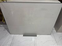 Front view of large whiteboard showing size and condition
