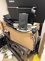 Pile of Lenovo ThinkCentre monitor, keyboards, Yealink box, speaker, network switch, phone handset