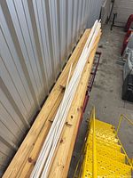 Stack of pine boards with white moulding strips on top
