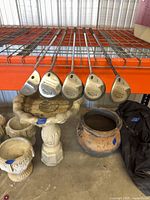 Five putters on shelf showing sole markings D, 3, 5, 7, L