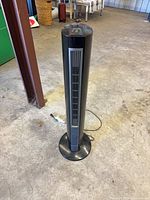 Full view of black tower heater fan on base