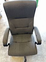 Front view of chair showing upholstery, backrest, armrests, wear