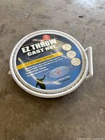 Top view of round EZ Throw cast net case showing product label