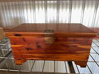 Closed chest showing exterior wood grain, latch, and feet