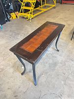 Top view showing wood surface with lighter center and scratches